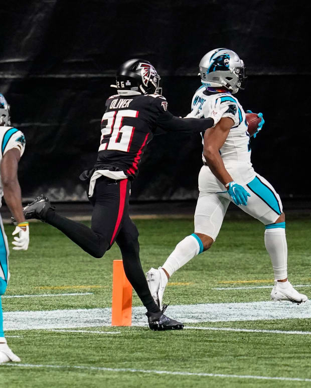 Oct 11, 2020; Atlanta, Georgia, USA; Carolina Panthers wide receiver DJ Moore (12) scores a touchdown behind Atlanta Falcons cornerback Isaiah Oliver (26) during the first half at Mercedes-Benz Stadium. Mandatory Credit: Dale Zanine-USA TODAY Sports
